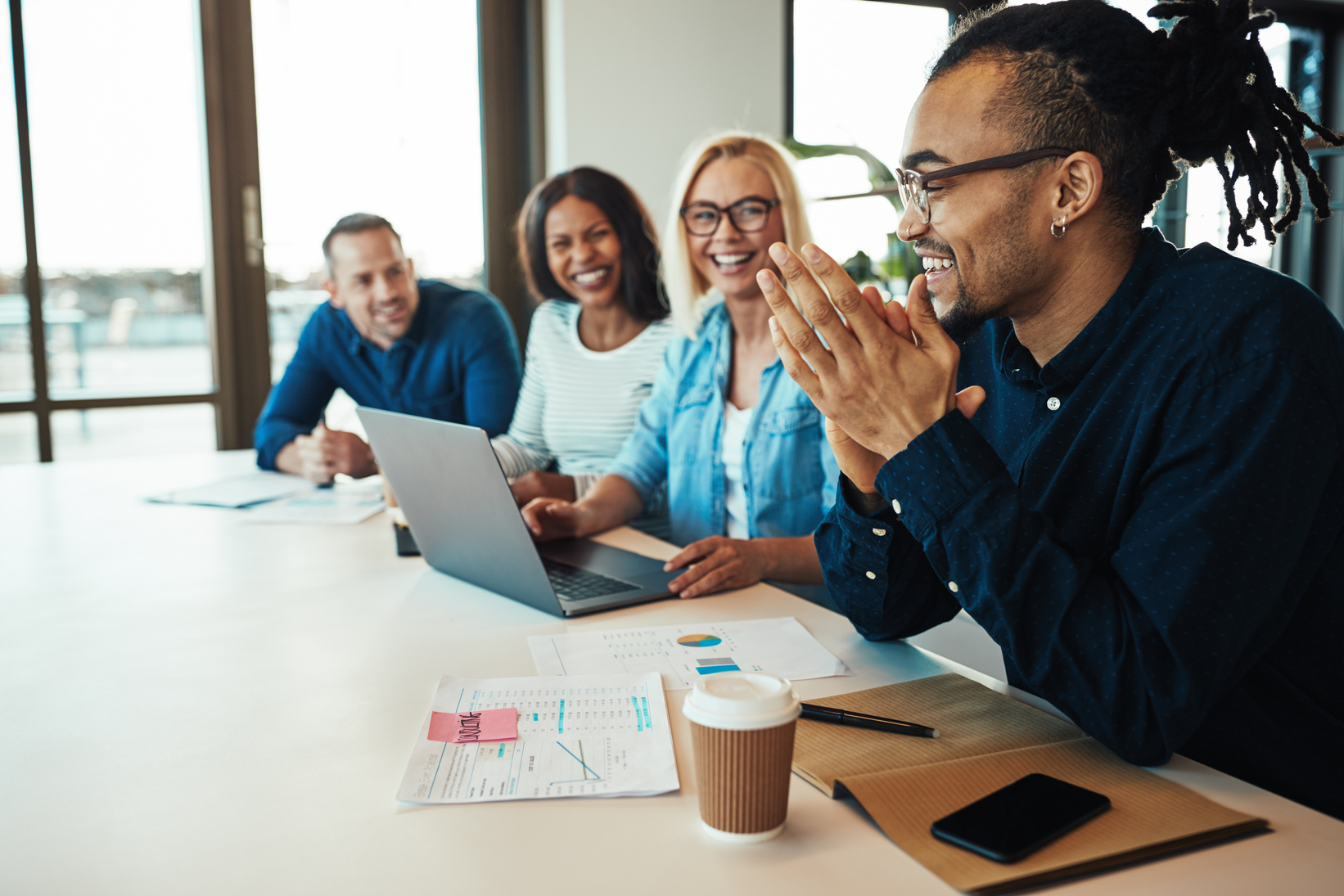 Office Workers Laughing in a Meeting